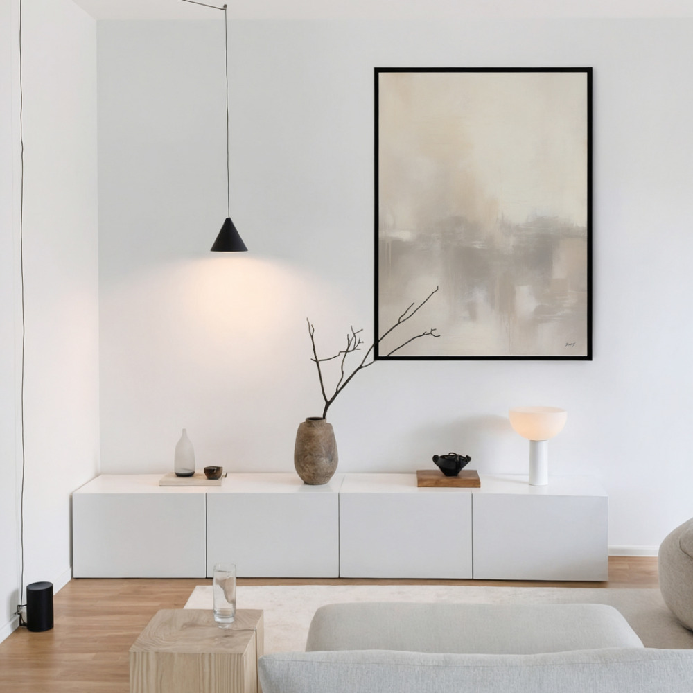Minimalist living room with abstract art, white console, and pendant light.