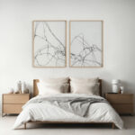Serene minimalist bedroom with abstract black line art above wooden bed frame.