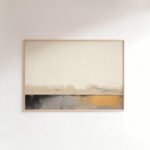 Abstract landscape artwork with neutral tones and gold accents in wooden frame