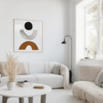 Abstract geometric artwork in bright minimal living room with white sofa and natural accents.