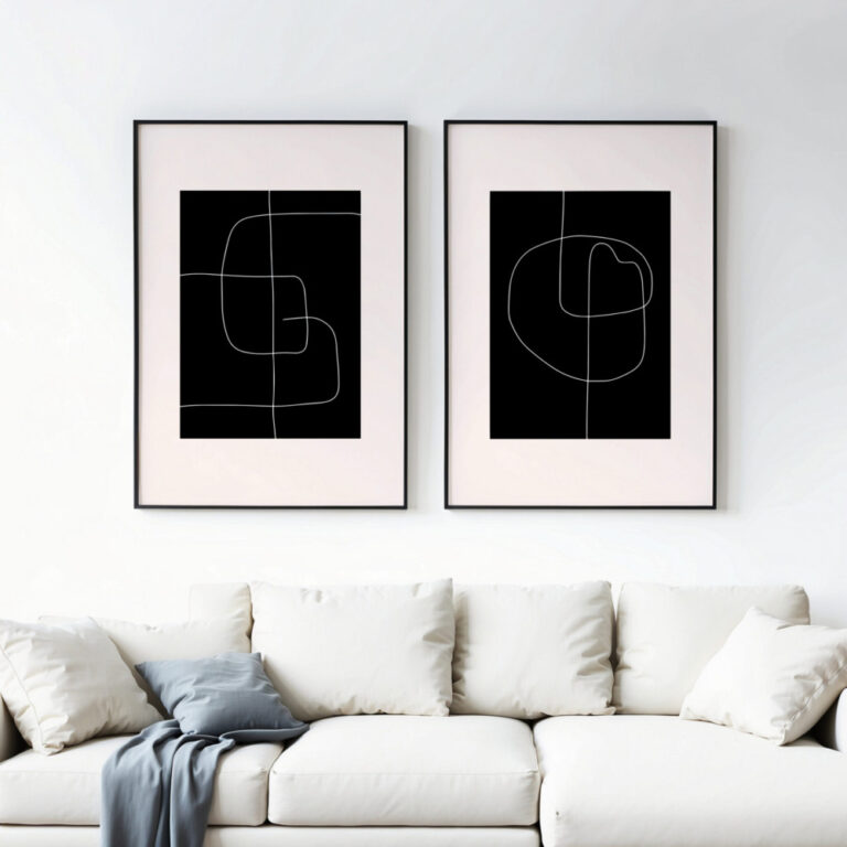 Minimalist black and white line art prints above white sofa in modern living room.