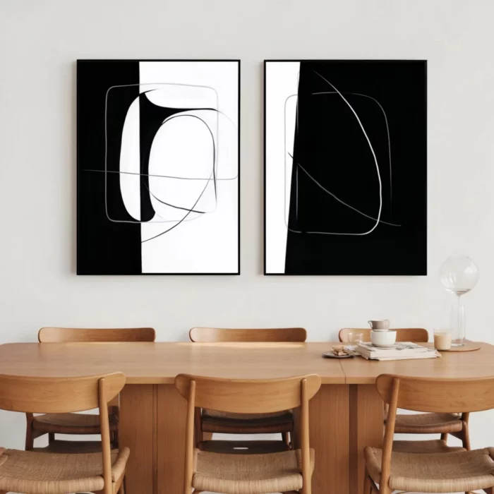 Minimalist black and white abstract art above modern wooden dining table set.