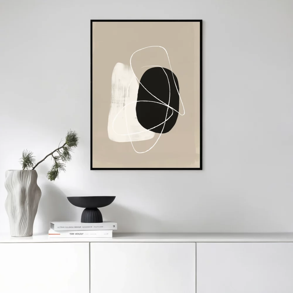 Abstract black and white wall art in minimalist interior with white cabinet.