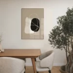 Minimalist dining space with abstract wall art, wooden table and indoor plant.