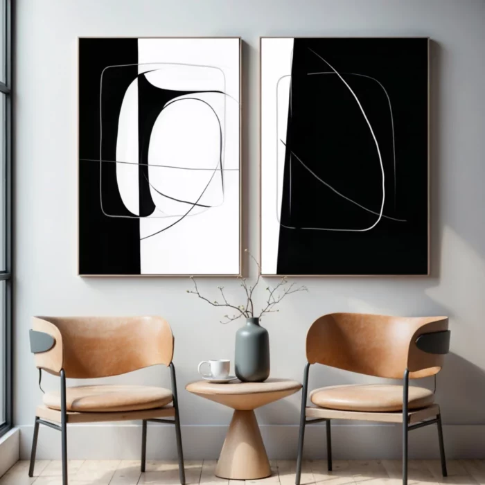 Abstract black and white diptych art above wooden table with chairs.
