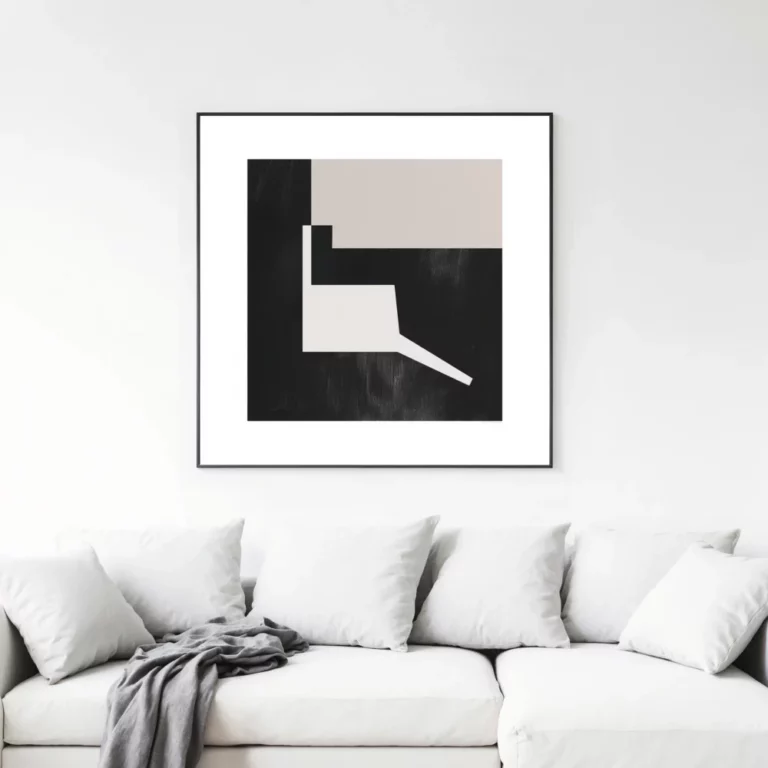 Minimalist black and beige geometric artwork displayed above modern white sofa.
