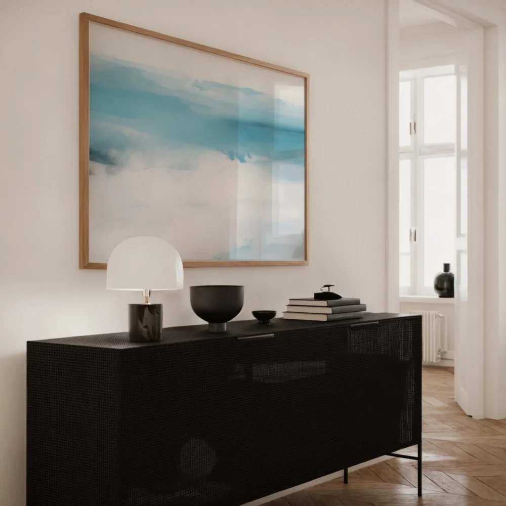 Sleek black credenza with minimalist styling beneath abstract blue seascape artwork.