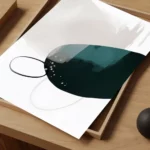 Abstract teal artwork with black line patterns displayed on wooden tray.
