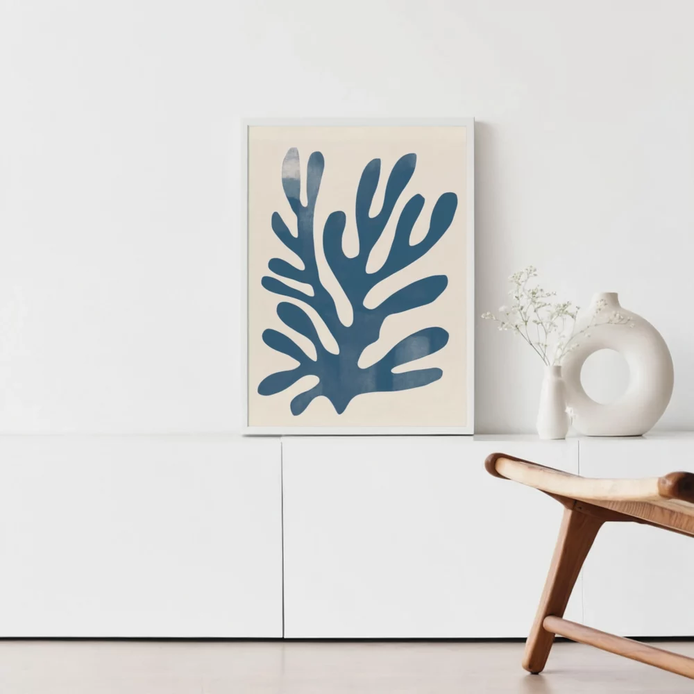 Minimalist blue Matisse-inspired artwork with white vase on modern cabinet.