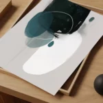 Elegant abstract artwork featuring teal curves and translucent shapes on wooden surface.