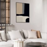 Elegant minimalist living room with abstract art and neutral-toned sectional sofa.