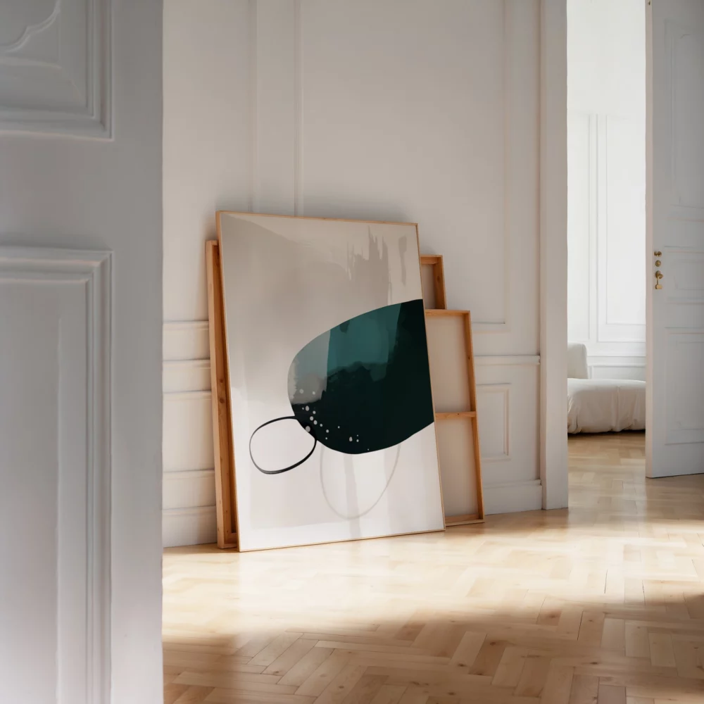 Minimalist teal abstract artwork leaning against white wall in sunlit room.