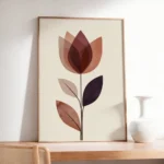 Framed abstract flower art print in warm earthy tones, placed on a light wooden console table next to a white vase, enhancing a minimalist interior.
