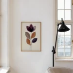 Framed abstract flower art print with layered purple and brown shapes, hung on a light wall above a wooden dining table by a large window in a bright dining space.
