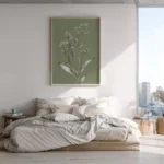Framed botanical illustration of a white-flowered plant on a muted olive green background, displayed above a bed with neutral bedding in a modern bedroom with city views.