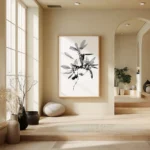 Large framed black and white line art print of a leafy sprig, hung on a light wall in a modern, minimalist hallway or transition space with steps and natural accents.