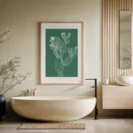 Framed white line art print of a cactus on a green background, displayed on a wall above a modern freestanding tub in a minimalist, spa-like bathroom.