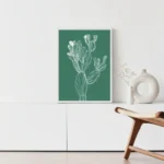 Framed white line art print of a cactus on a deep green background, displayed above a white console table with a minimalist vase in a modern living room.